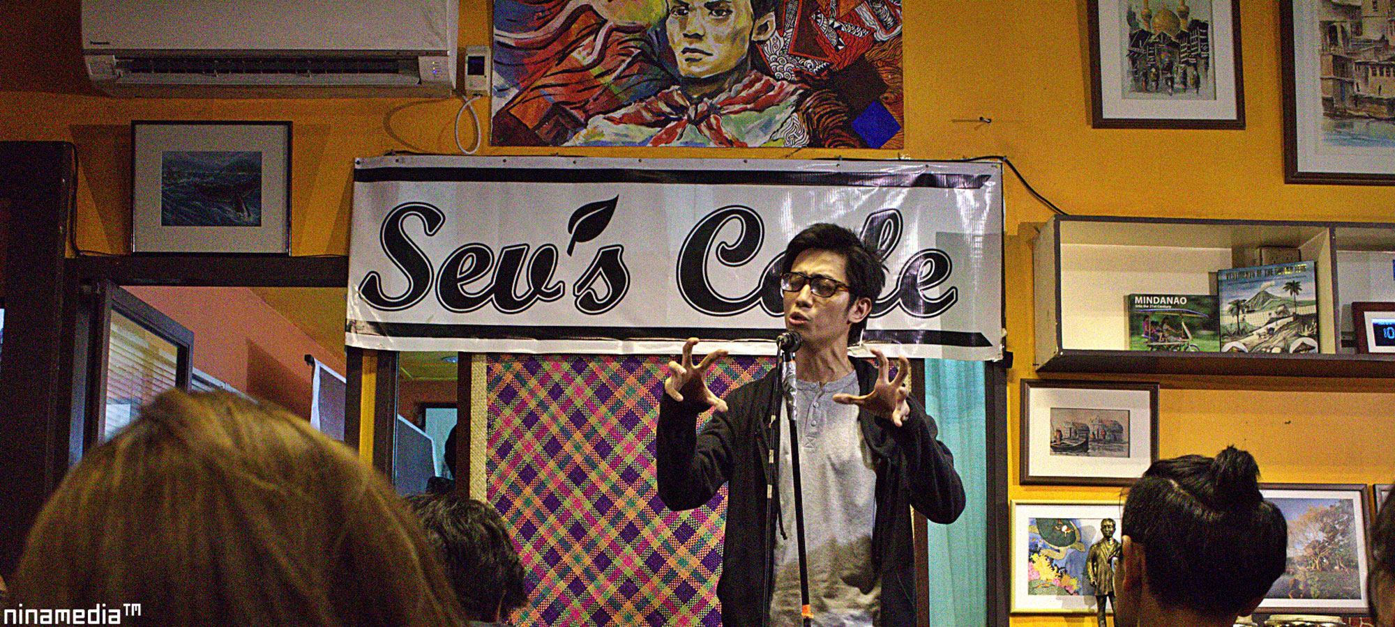 Growth Rocket John Berida performing spoken word at Sev’s Cafe