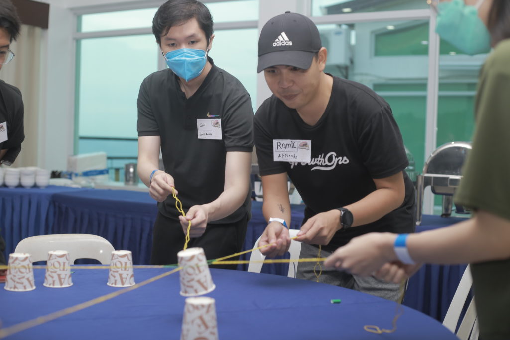 Ramil and Jean moving a cup with rubber bands