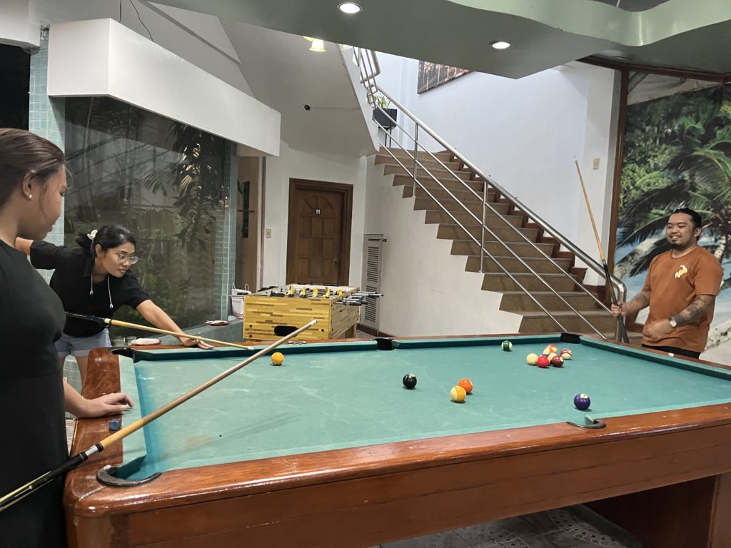 AJ, Kaloy, and Bhea playing billiards