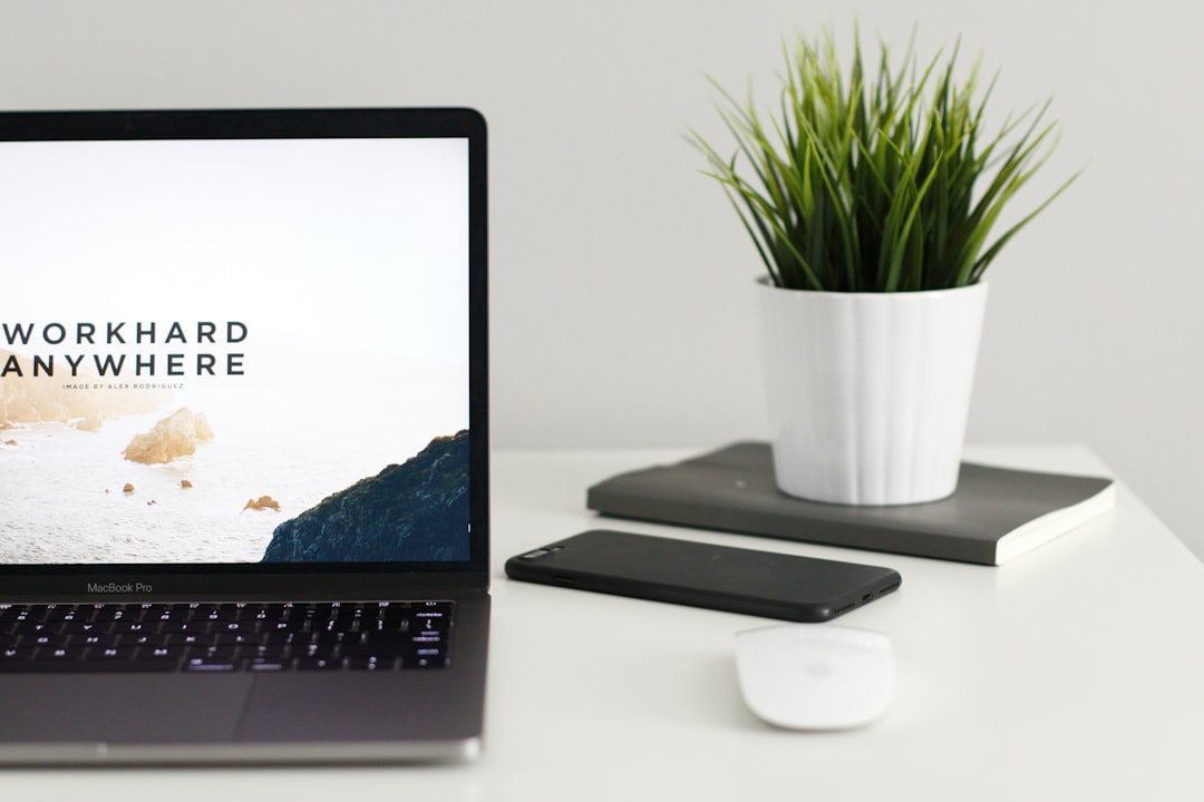 Growth Rocket MacBook Pro near green potted plant on table