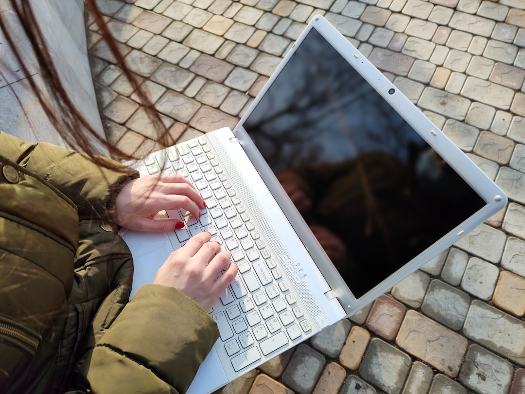 Growth Rocket a woman is typing on a laptop outside